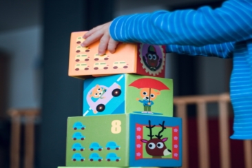 child building an four boxes