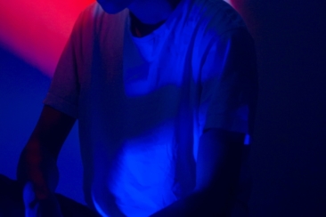 photo of man wearing white shirt with red and blue light background
