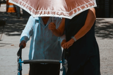 woman holding umbrella while walking