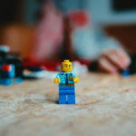 lego mini figure on brown wooden table