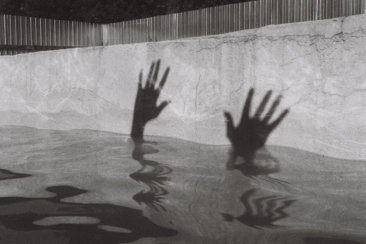 person in water in grayscale photography