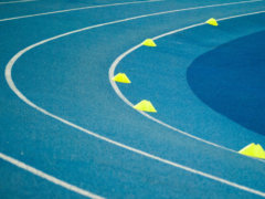 blue curved track field at daytime