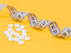 white round medication pill on yellow surface
