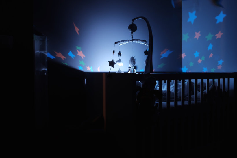 baby's black wooden crib with LED crib mobile