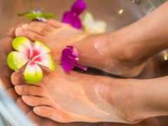 person's feet with flowers