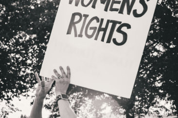 a protester holding a sign that reads protect women's rights